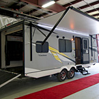 Adrenline 21LT Exterior Rear 3/4 View Showing Ramp Door Down and Awning Extended May Show Optional Features. Features and Options Subject to Change Without Notice.