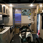 Adrenline 21LT Interior Back to Front Showing Motorcycle Set Up Inside Kitchen Area May Show Optional Features. Features and Options Subject to Change Without Notice.