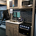 Adrenline 21LT Interior Kitchen with Decorative Backsplash May Show Optional Features. Features and Options Subject to Change Without Notice.
