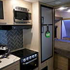 Adrenline 21LT Interior Showing Microwave, Stove with Glass Cover and Refrigerator May Show Optional Features. Features and Options Subject to Change Without Notice.