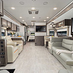 Mirada Interior showing the living area and kitchen from the front to back of the motorhome. May Show Optional Features. Features and Options Subject to Change Without Notice.