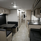 Interior of the 300BHS, Front to Back View of Dinette with Over Head Cabinets, Bunk Room, Kitchen and Sofa May Show Optional Features. Features and Options Subject to Change Without Notice.
