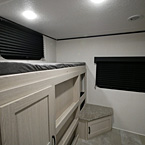Bunk Room Window Next to Bunk with Storage Cubbies Underneath, Carpeted Seat with Storage Cubbie next to Large Rear Window  May Show Optional Features. Features and Options Subject to Change Without Notice.