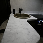 L- Shaped Thermofoil Countertop with a Single Bowl Sink with Faucet, Pop-Up Outlets & USB Ports
 May Show Optional Features. Features and Options Subject to Change Without Notice.