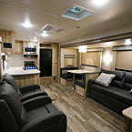 Interior Front to Back View, Showing 2 Lounge Recliners, Kitchen, Booth Dinette and Opinion Tri-Fold Sofa
 May Show Optional Features. Features and Options Subject to Change Without Notice.