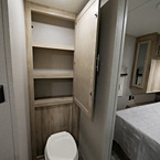 Linen Closet Shown Open with Two Shelves Above Foot Flush Toilet May Show Optional Features. Features and Options Subject to Change Without Notice.
