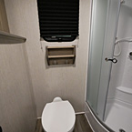 Porcelain Foot Flush Toilet Under Window and Shelf with Two Towel Hooks 
 May Show Optional Features. Features and Options Subject to Change Without Notice.