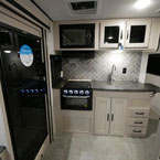 Refrigerator Next to Microwave Overhead and Two Cabinet Doors, Below Cook Top and Stove Next to Stainless Steel Faucet and Sink Shown with Sink Cover and Counter Top Extension, Two Cabinet Doors and Three Drawers Below Sink
 May Show Optional Features. Features and Options Subject to Change Without Notice.