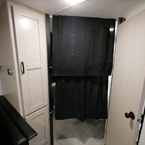 Partial of Pantry Door Shown, Two Black Privacy Curtains Shown Extended Next to Bathroom Door Shown Closed
 May Show Optional Features. Features and Options Subject to Change Without Notice.