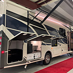 Rear view of Mirada 29FW, 5,000 Towing Hitch with 7-Way Plug, Rear Mounted Roof Ladder, Power Patio Awning extended with Speakers, Exterior Kitchen
 May Show Optional Features. Features and Options Subject to Change Without Notice.
