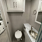 View of Bathroom, Porcelain Toilet with Foot Flush and cabinet
 May Show Optional Features. Features and Options Subject to Change Without Notice.