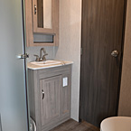 Bathroom - Shower, Medicine Cabinet Above Sink, Foot Flush Toilet, and Closed Door to Bedroom
 May Show Optional Features. Features and Options Subject to Change Without Notice.