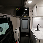 Door Between Passenger Seat and Kitchen with Television Overhead
 May Show Optional Features. Features and Options Subject to Change Without Notice.
