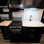 Three Burner Cook Top with Glass Cover Shown Open. Sink Cover Over Sink.

 May Show Optional Features. Features and Options Subject to Change Without Notice.