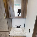 Bathroom sink, mirror, and storage May Show Optional Features. Features and Options Subject to Change Without Notice.