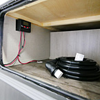 Pass Through Storage Shown Open with Optional Solar Controller {Part of the Off-Grid Solar Package}.
 May Show Optional Features. Features and Options Subject to Change Without Notice.