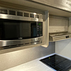 Stainless Steel Microwave Shown Overhead Next to Cabinet.
 May Show Optional Features. Features and Options Subject to Change Without Notice.