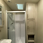 Mirrored Medicine Cabinet Above Vanity, Glass Shower Doors, Two Door Linen Closet Next to Shower.
 May Show Optional Features. Features and Options Subject to Change Without Notice.