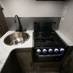 Single Bowl Stainless Steel Sink with Black Faucet Next to Three Burner Cook Stove Top.
 May Show Optional Features. Features and Options Subject to Change Without Notice.