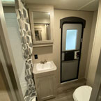 Bathroom with Entry Door, Shower, Mirrored Medicine Cabinet with Single Bowl Vanity Below, Part of Toilet Shown.
 May Show Optional Features. Features and Options Subject to Change Without Notice.