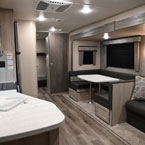 Interior From Front to Back- Part of Kitchen Area Shown, Part of Bunk Room Shown, U-Shaped Dinette and Sofa.
 May Show Optional Features. Features and Options Subject to Change Without Notice.