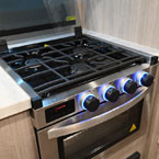 Stove Glass Top Shown Open, Three Burner Cook Top with Blue LED Knobs.
 May Show Optional Features. Features and Options Subject to Change Without Notice.