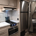 Interior with Kitchen Galley Area. Double Over Double Bunks with Privacy Curtain.
 May Show Optional Features. Features and Options Subject to Change Without Notice.