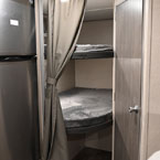 Part of Stainless Steel Refrigerator Shown Next to Double Over Double Bunks. Bathroom Door Shown Closed.
 May Show Optional Features. Features and Options Subject to Change Without Notice.