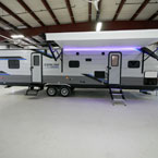 Door Side with Awning and Optional Solid Steps Extended. LED Light Strip Shown in Purple.  Baggage Door Shown Open.
 May Show Optional Features. Features and Options Subject to Change Without Notice.
