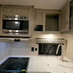 Cabinet Overhead of Sink Shown Open.
 May Show Optional Features. Features and Options Subject to Change Without Notice.