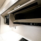 Cabinet Overhead of Stove Shown Open.
 May Show Optional Features. Features and Options Subject to Change Without Notice.