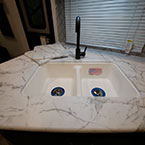 White Stonecast Double Bowl Sink with Black Faucet.
 May Show Optional Features. Features and Options Subject to Change Without Notice.