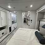 View Of King Bed In Bedroom Facing The Front Of The Coach, With Partial View Of The Bathroom And Into The Kitchen And Galley
 May Show Optional Features. Features and Options Subject to Change Without Notice.