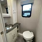 View Of Bathroom, Stainless Lavatory Sink, Cabinets, Mirror And Porcelain Toilet With Foot Flush
 May Show Optional Features. Features and Options Subject to Change Without Notice.