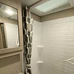 View of bathroom, shower, and sink with mirror
 May Show Optional Features. Features and Options Subject to Change Without Notice.