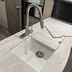 Kitchen sink with under-mounted farm style basin and residential faucet with pull-down sprayer with counter-cover shown half off May Show Optional Features. Features and Options Subject to Change Without Notice.
