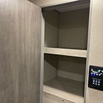 Pantry storage cabinet next to entry door with cabinet doors shown open and LCI one control monitor panel system
 May Show Optional Features. Features and Options Subject to Change Without Notice.