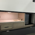 Exterior camper kitchen with panel door shown open  May Show Optional Features. Features and Options Subject to Change Without Notice.