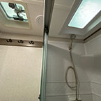 Shower with skylight and sliding glass door, roof vent with fan, and linen rack May Show Optional Features. Features and Options Subject to Change Without Notice.